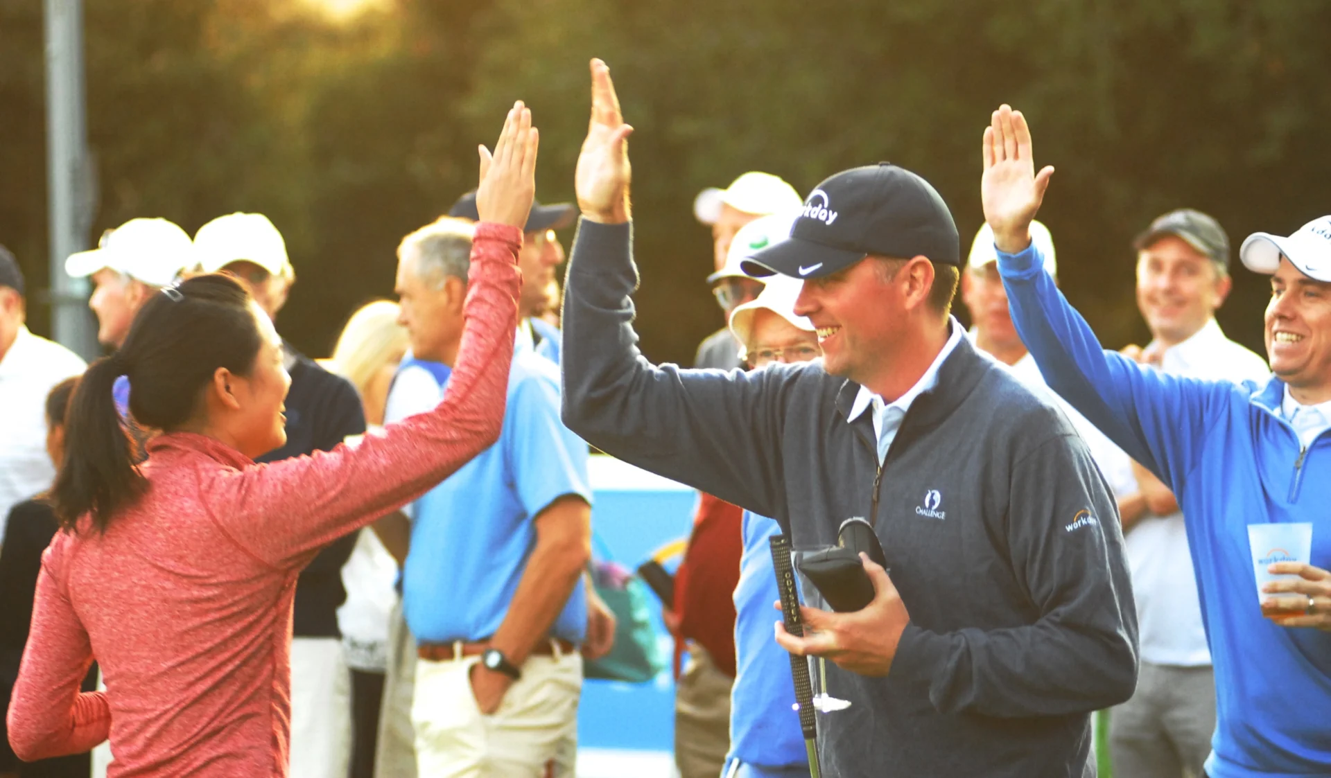 Golfer giving a high-five to a fan.